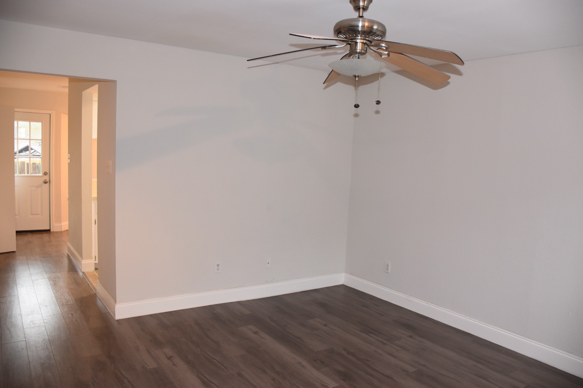 1810 Rawhide Loop Round Rock, TX 78681 - Photo 7 of 29 Spacious room featuring wood-finish flooring, light neutral wall paint, and crisp white baseboards
