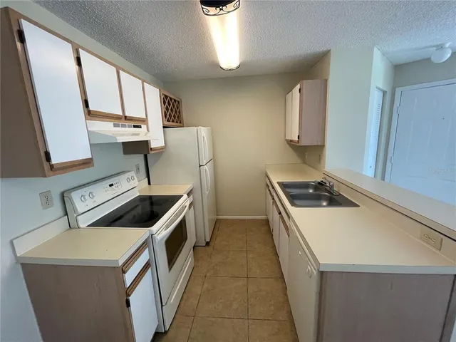 a kitchen that has a sink and a stove