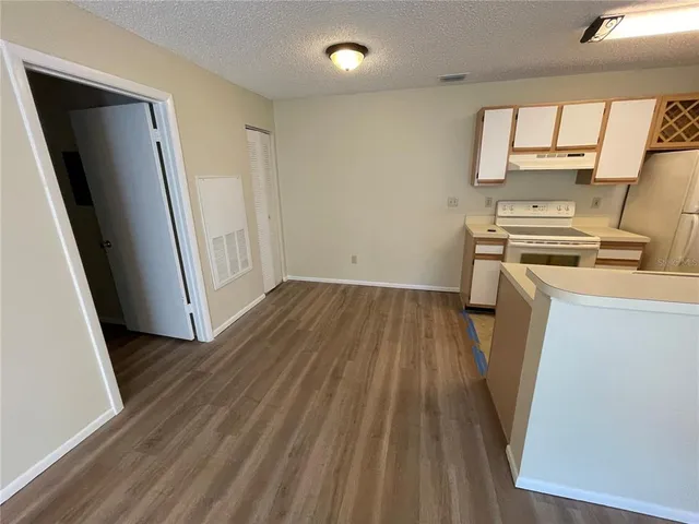 a view of a kitchen with wooden floor and a sink