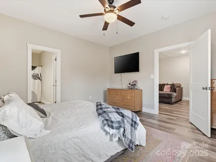 a bedroom with a bed and a flat screen tv