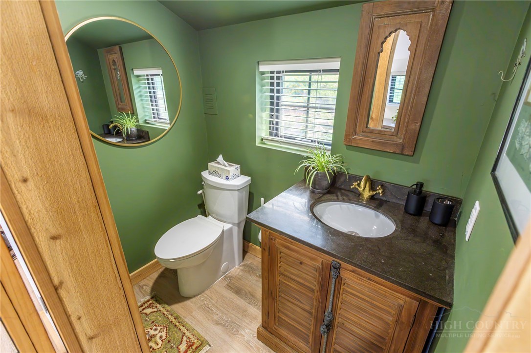 509 Grant Houck Road Todd, NC 28684 - Photo 40 of 43 a bathroom with a toilet sink and mirror