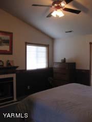 971 Sheep Co Road Selah, WA 98942 - Photo 23 of 44 a bedroom with a bed and a flat tv screen on dresser