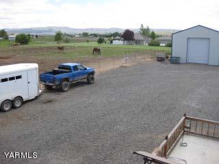 971 Sheep Co Road Selah, WA 98942 - Photo 36 of 44 a view of a lake with lawn chairs and a barbeque