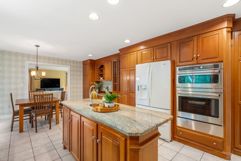 8 Stoneybrook Circle Andover, MA 01810 - Photo 11 of 37 a kitchen with stainless steel appliances kitchen island granite countertop a refrigerator and microwave