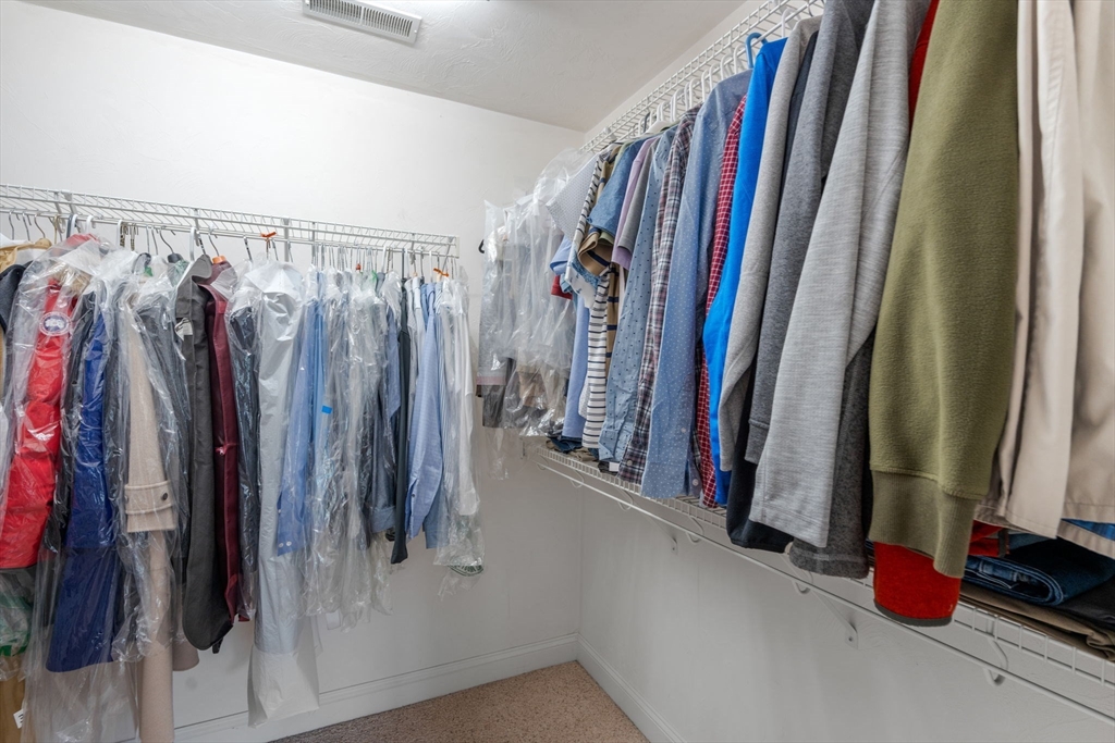 8 Stoneybrook Circle Andover, MA 01810 - Photo 19 of 37 a view of walk in closet with clothes and shoes