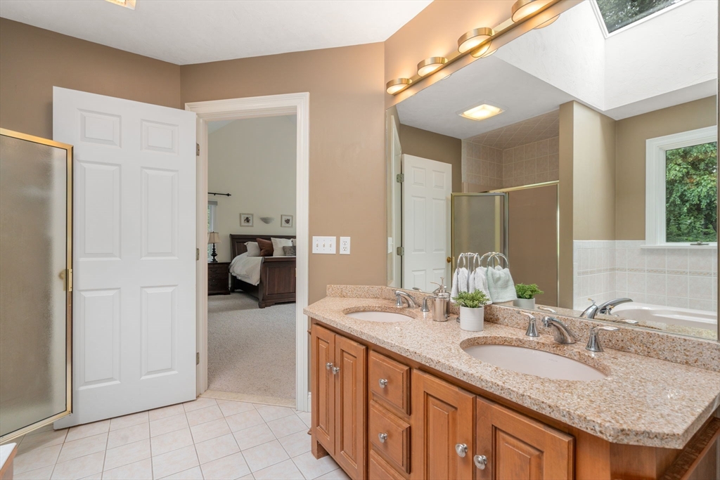 8 Stoneybrook Circle Andover, MA 01810 - Photo 21 of 37 a en suite bathroom with a granite countertop sink and a mirror