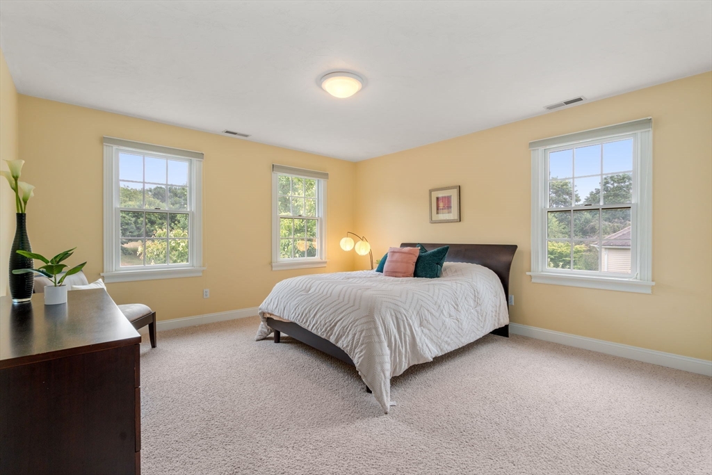 8 Stoneybrook Circle Andover, MA 01810 - Photo 22 of 37 a spacious bedroom with a large bed and a window