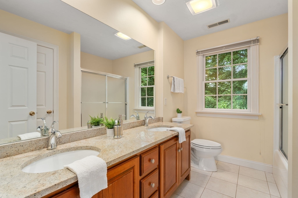 8 Stoneybrook Circle Andover, MA 01810 - Photo 23 of 37 a bathroom with a granite countertop sink and a large mirror