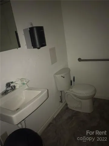 a white toilet sitting next to a bathroom sink