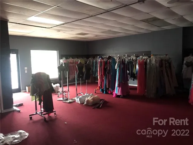 a view of a room with gym equipment and a large window