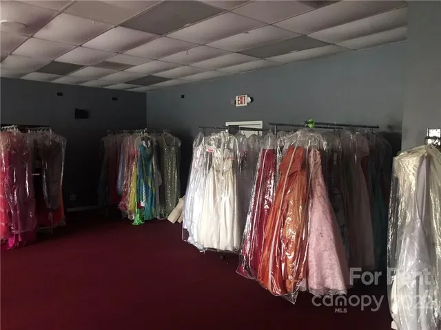 a view of walk in closet with clothes