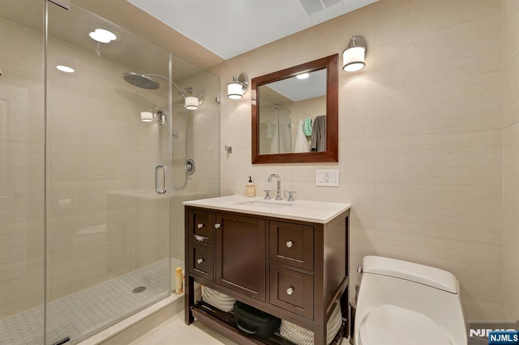 2 Horizon Road, Unit G1 Fort Lee, NJ 07024 - Photo 33 of 44 a bathroom with a sink toilet a mirror and shower