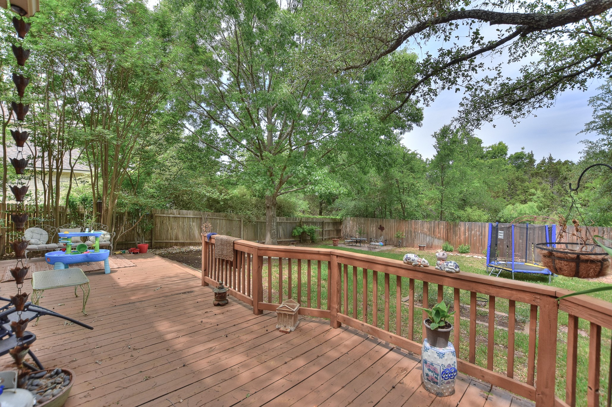 1609 Colton Way Cedar Park, TX 78613 - Photo 15 of 24 A spacious wooden deck provides ample outdoor living space, leading to a generously sized, fenced backyard oasis.