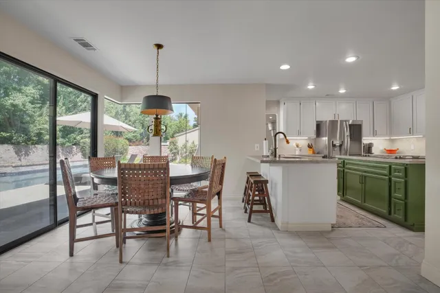 a dining room filled kitchen with a table and chairs in it