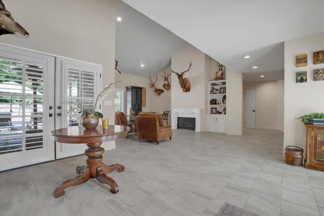 a view of a livingroom with furniture and a large window