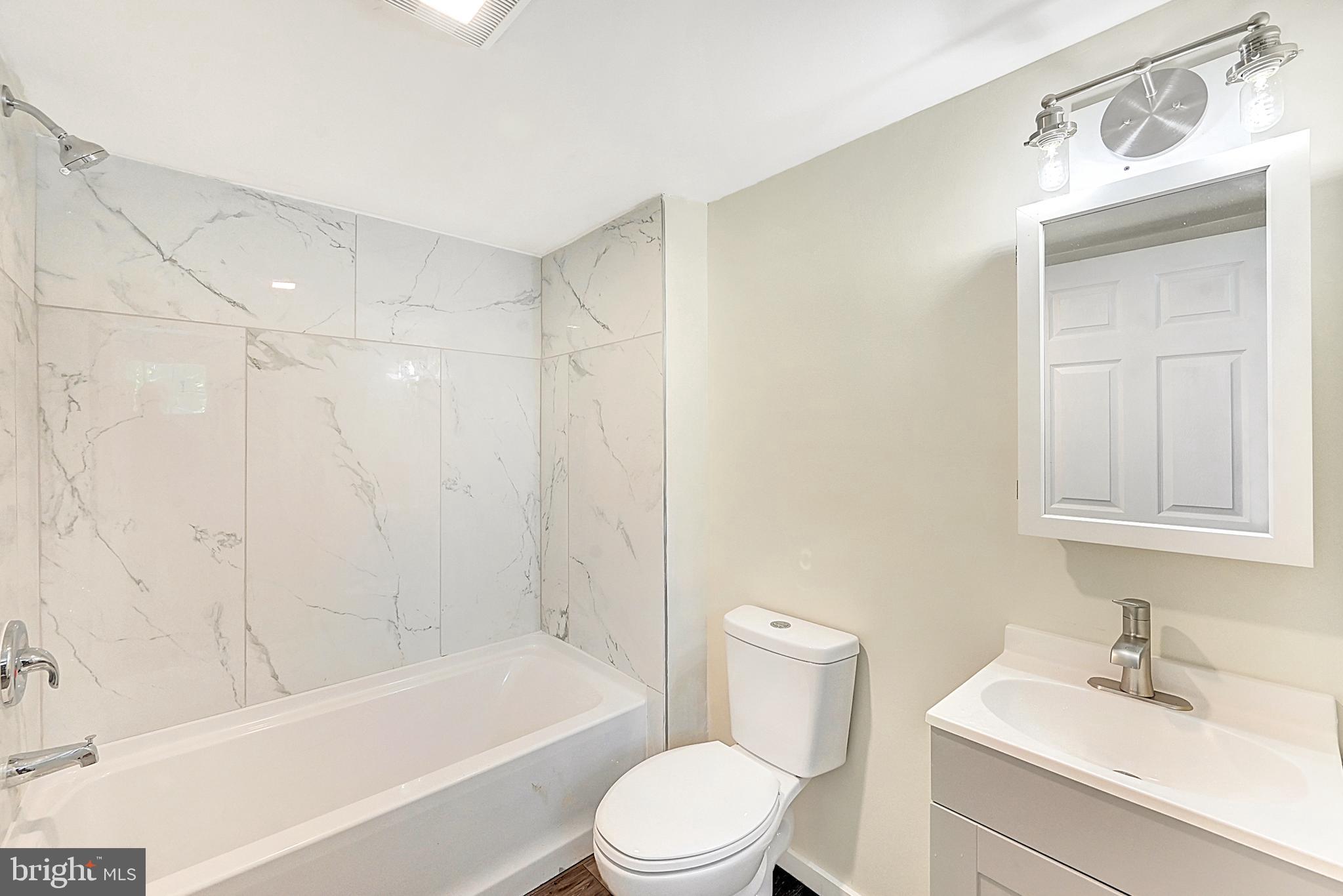 215 Freysville Road York, PA 17406 - Photo 11 of 19 a bathroom with a bathtub shower sink vanity mirror and toilet