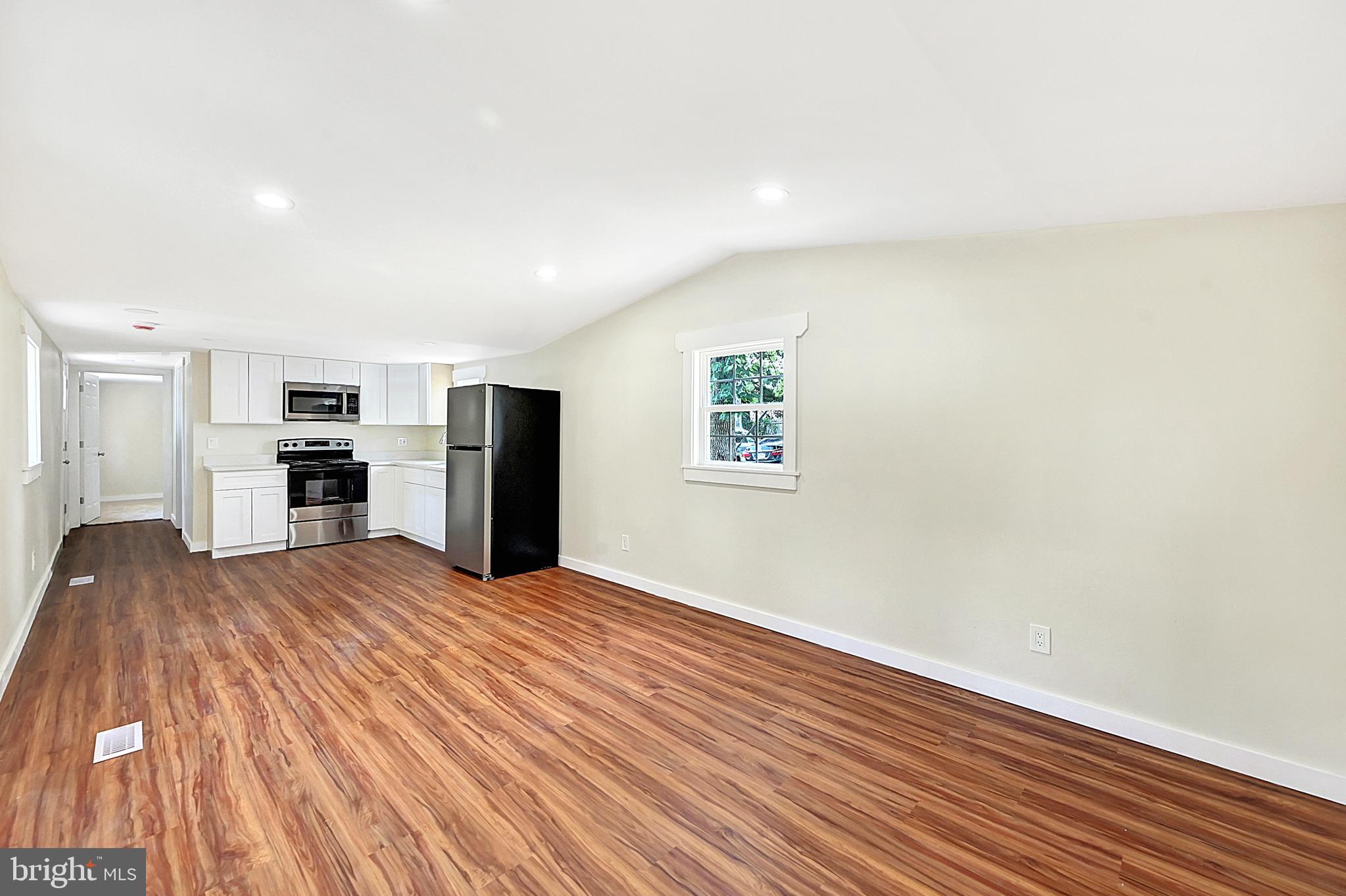 215 Freysville Road York, PA 17406 - Photo 7 of 19 a view of a kitchen with refrigerator and wooden floor