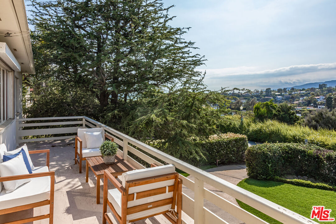 540 Adelaide Drive Santa Monica, CA 90402 - Photo 29 of 45 a view of a balcony with two chairs and a table