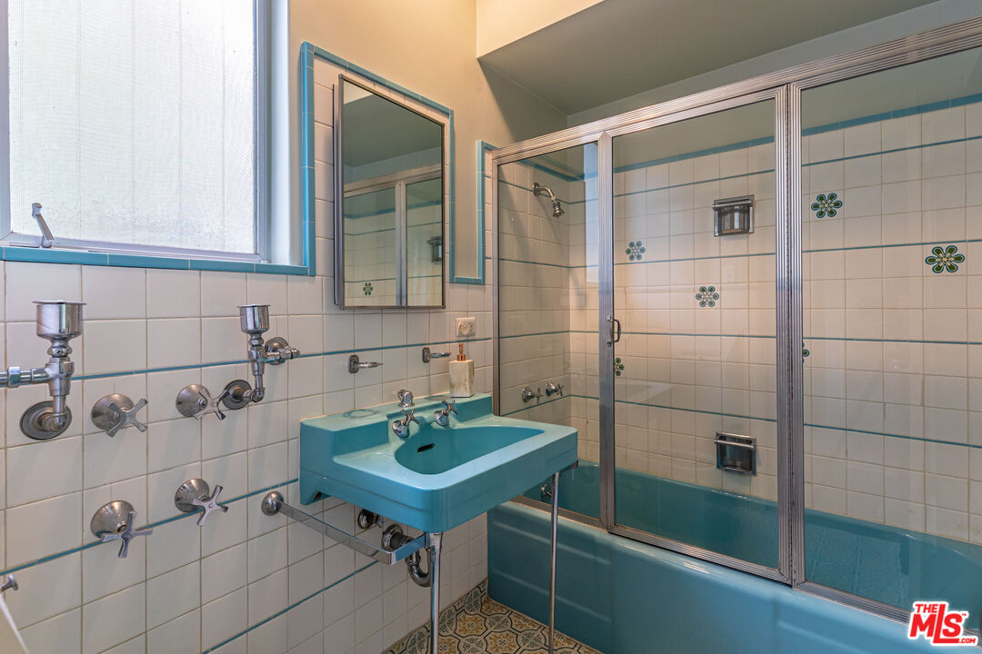 540 Adelaide Drive Santa Monica, CA 90402 - Photo 34 of 45 a bathroom with a sink and a mirror