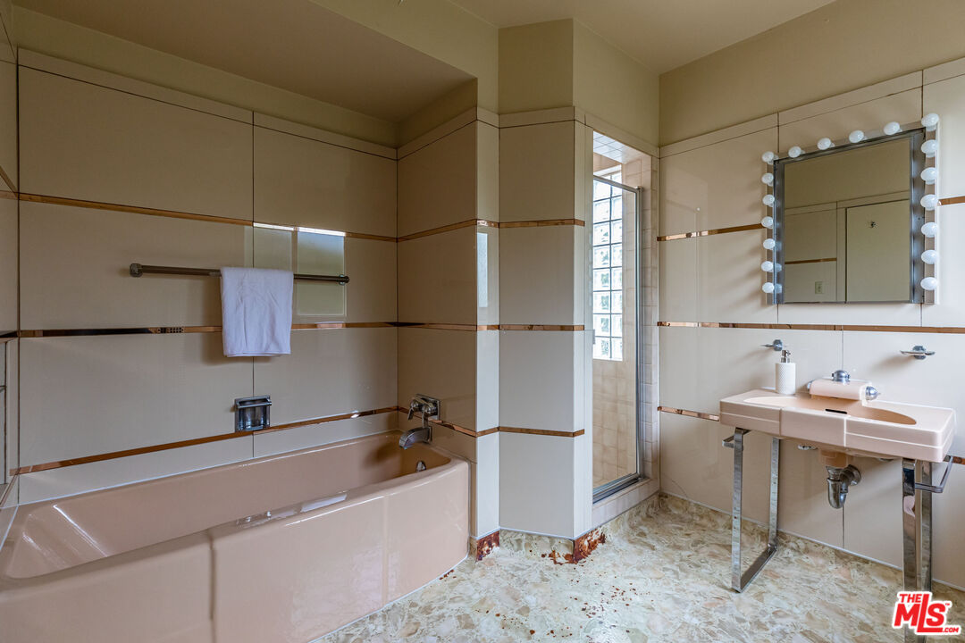 540 Adelaide Drive Santa Monica, CA 90402 - Photo 36 of 45 a bathroom with a sink and a mirror