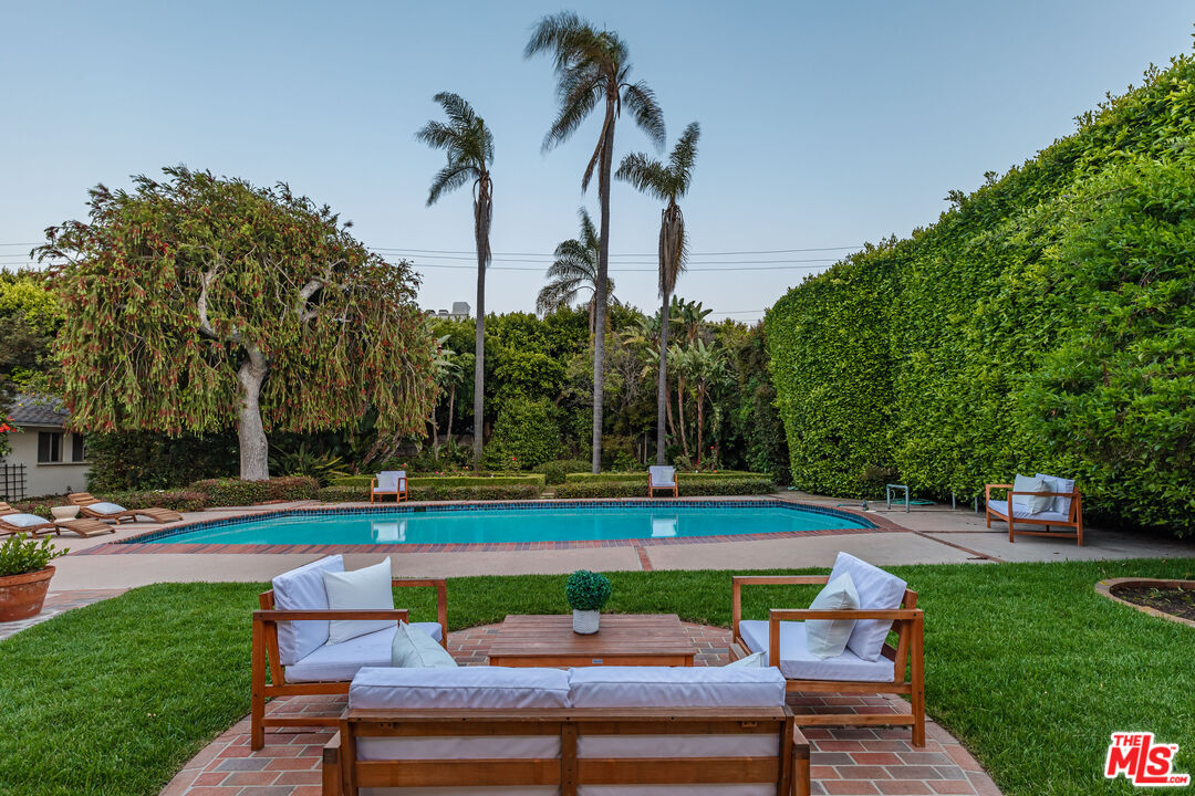 540 Adelaide Drive Santa Monica, CA 90402 - Photo 41 of 45 a view of a swimming pool with a bench and trees