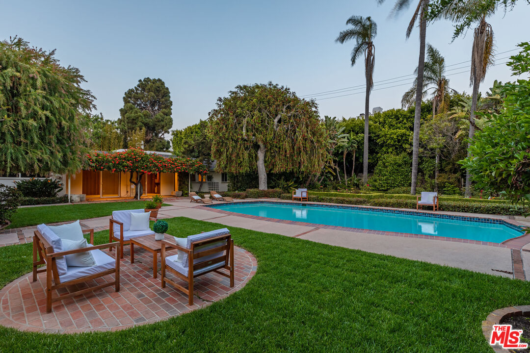 540 Adelaide Drive Santa Monica, CA 90402 - Photo 42 of 45 a view of a swimming pool with lawn chairs and a big yard