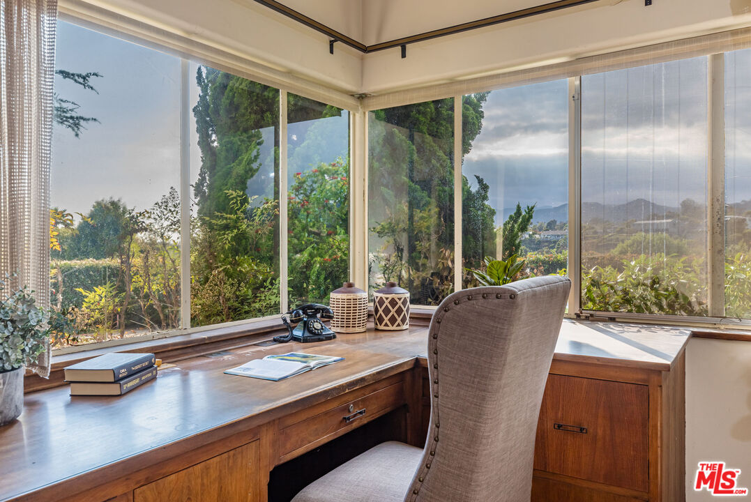540 Adelaide Drive Santa Monica, CA 90402 - Photo 7 of 45 a view of a patio with a table chairs and floor to ceiling window