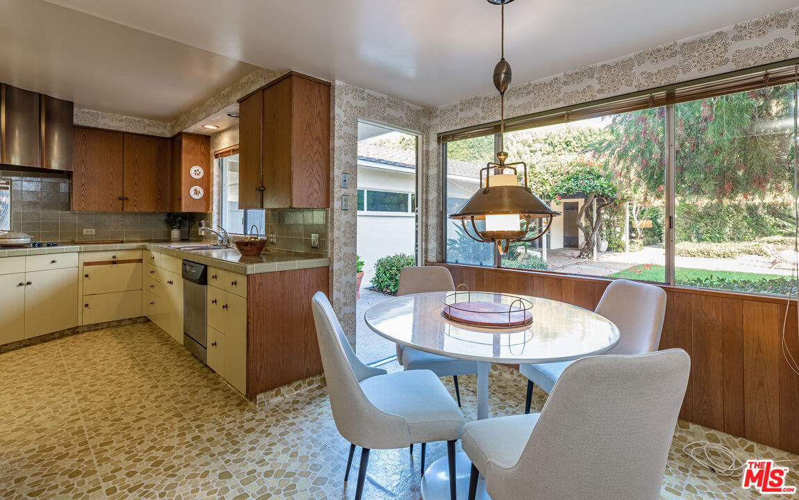 540 Adelaide Drive Santa Monica, CA 90402 - Photo 10 of 45 a dining room with furniture a chandelier and wooden floor
