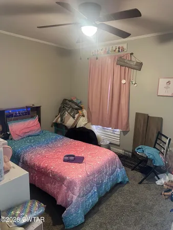 a bedroom with a bed and a chair