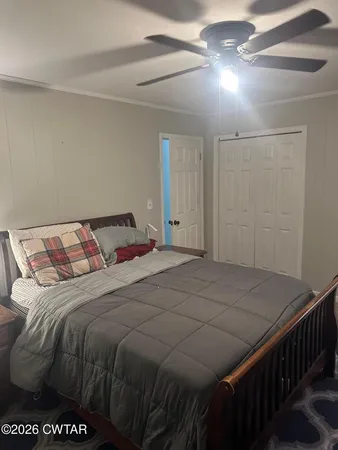 a bedroom with a bed and a night stand