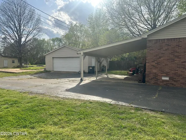 a backyard of a house with table and chairs