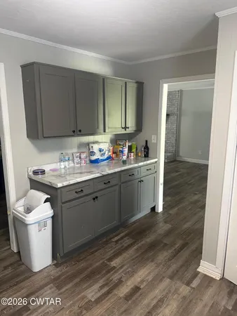 a kitchen with a sink and a stove top oven