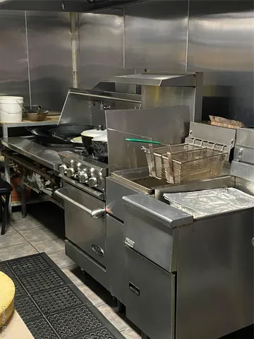 a stove top oven sitting inside of a kitchen