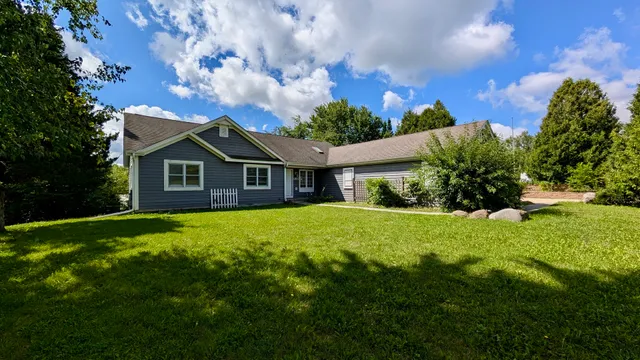 a front view of a house with a garden