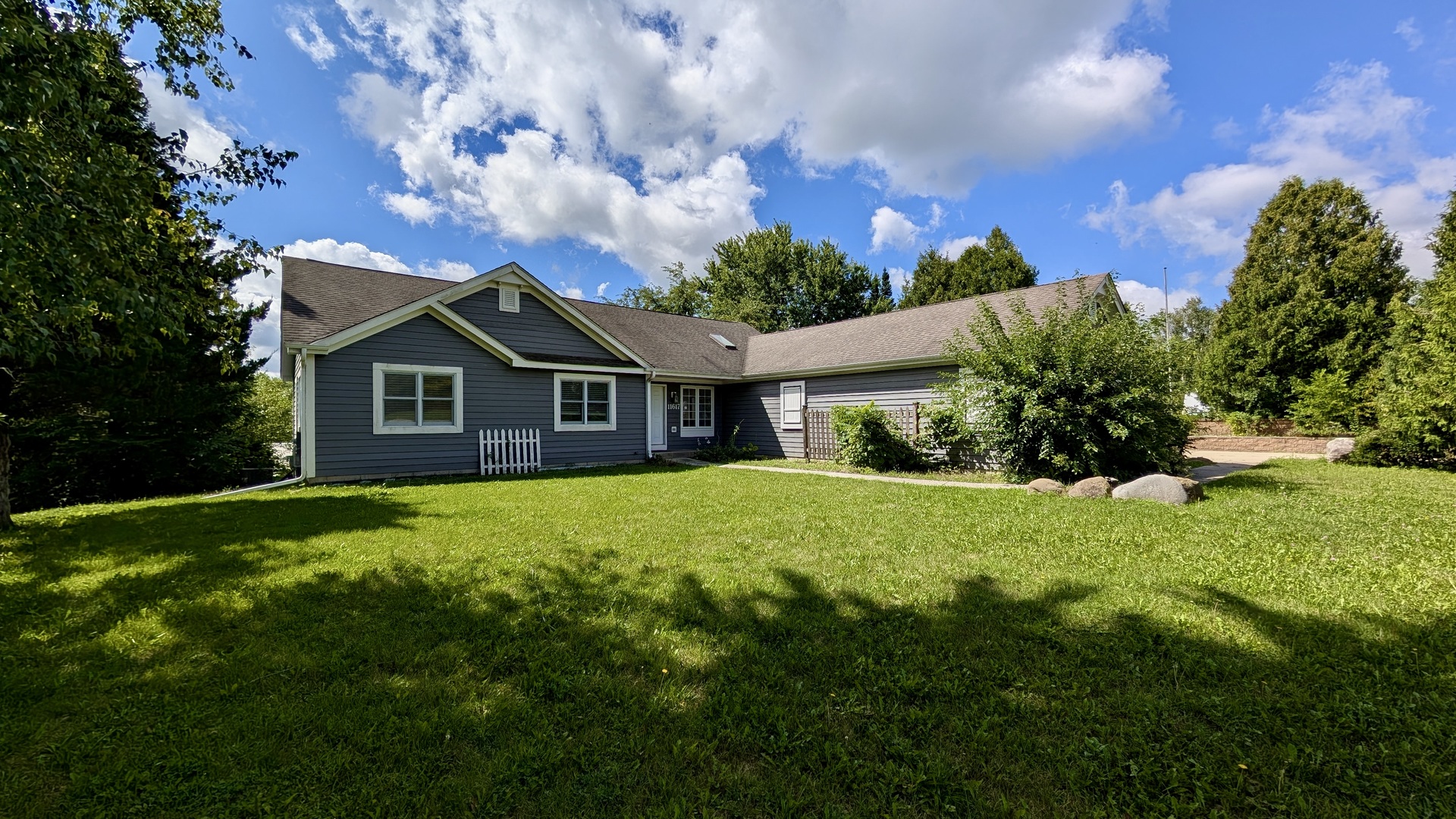 11617 Hawthorne Way Huntley, IL 60142 - Photo 1 of 50 a front view of a house with a garden