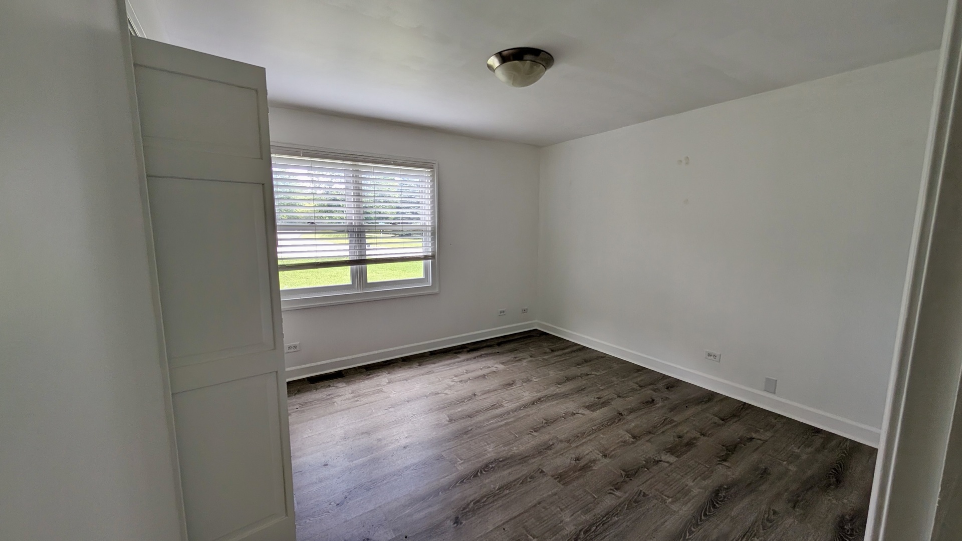 11617 Hawthorne Way Huntley, IL 60142 - Photo 12 of 50 an empty room with wooden floor and windows