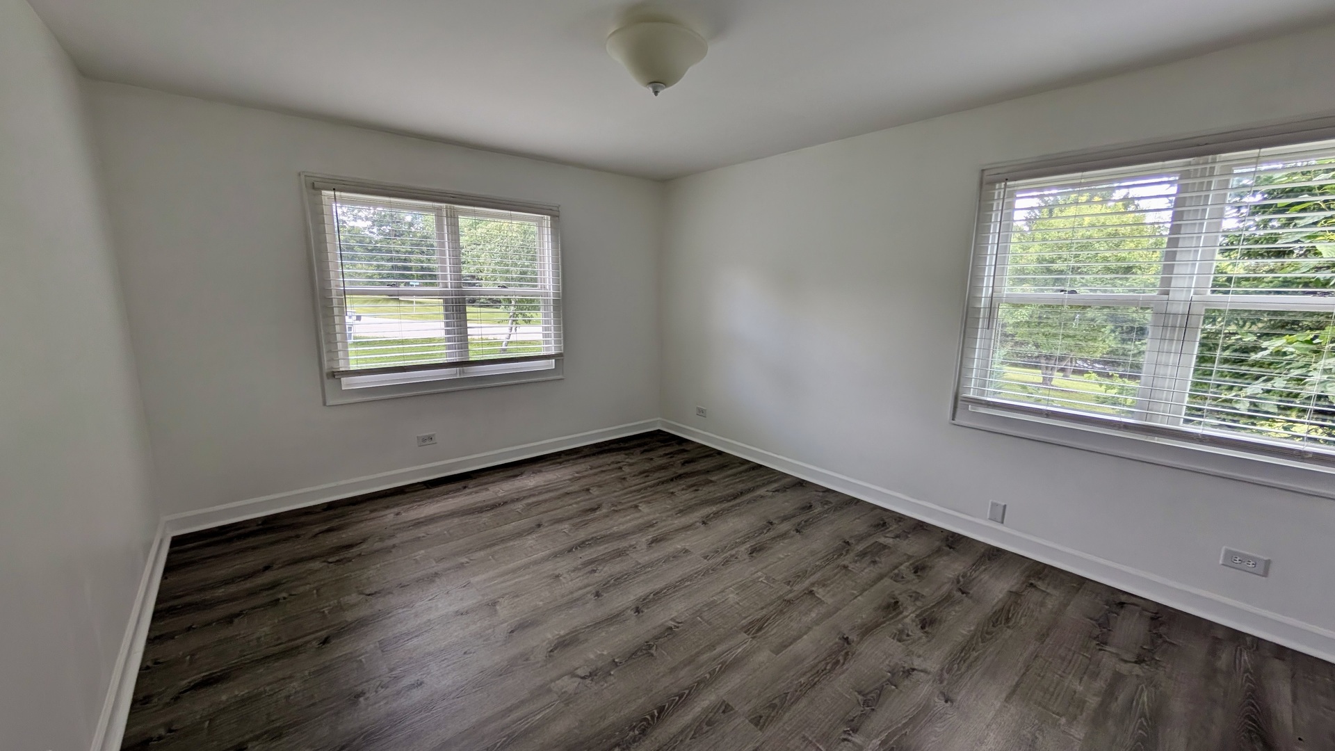 11617 Hawthorne Way Huntley, IL 60142 - Photo 16 of 50 a view of an empty room with wooden floor and a window