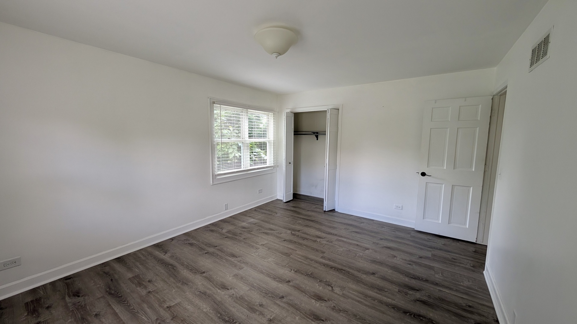 11617 Hawthorne Way Huntley, IL 60142 - Photo 17 of 50 an empty room with wooden floor and windows