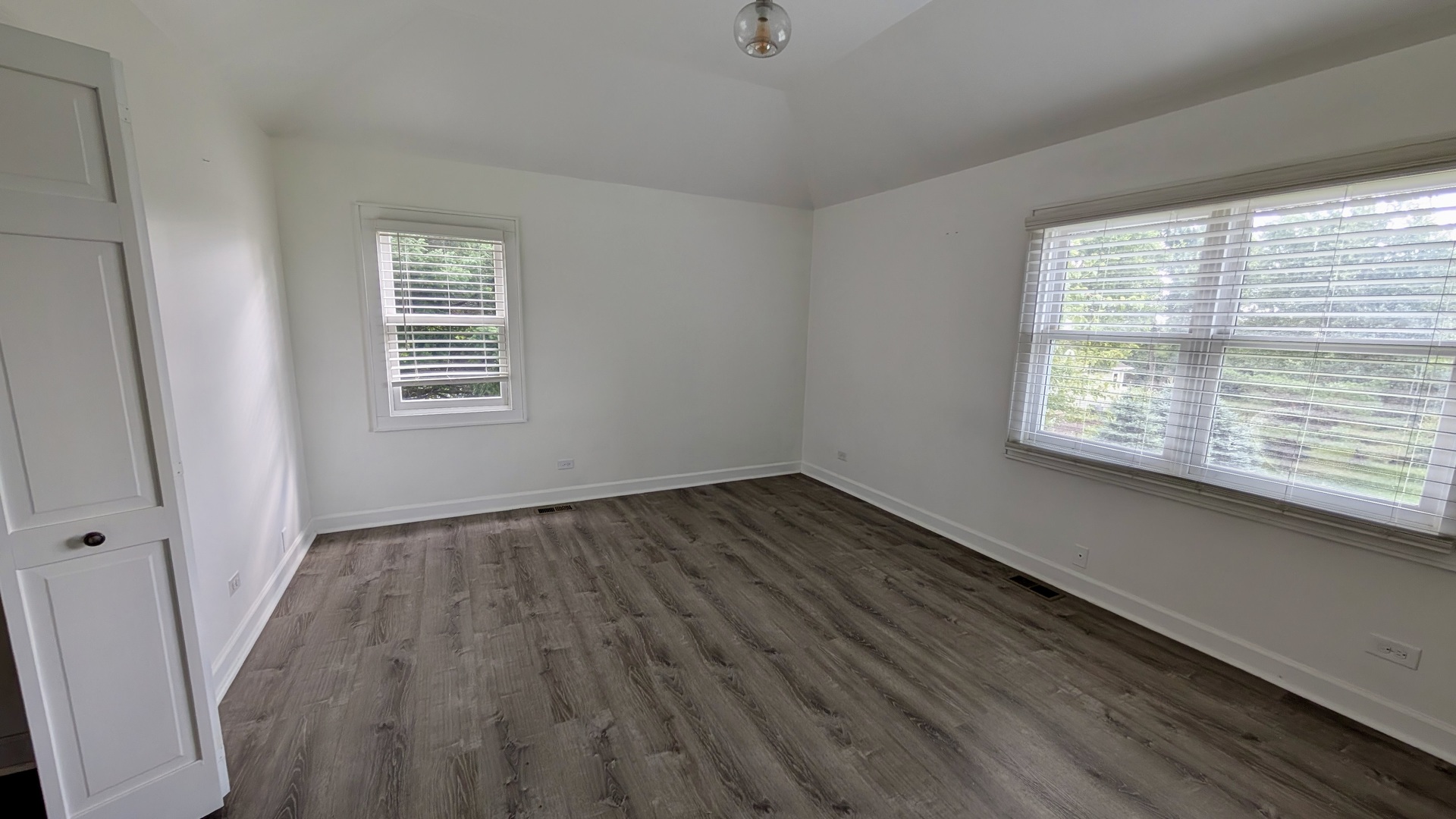 11617 Hawthorne Way Huntley, IL 60142 - Photo 21 of 50 a view of an empty room with wooden floor and a window