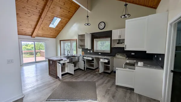a kitchen with a large window cabinets and stainless steel appliances
