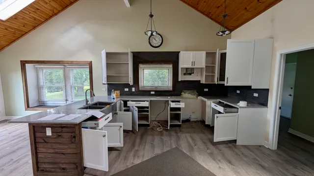 a kitchen with granite countertop a stove and cabinets