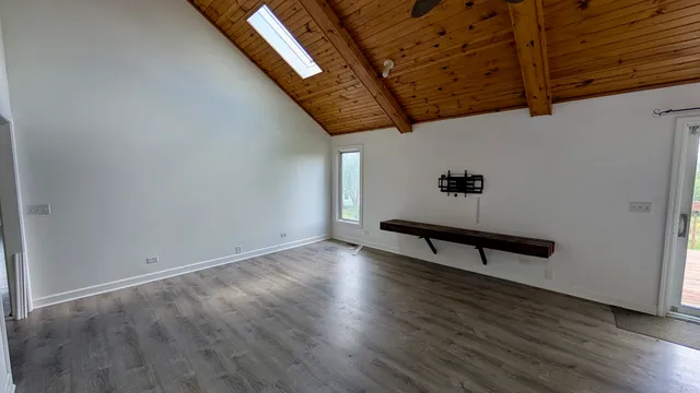 a view of a room with wooden floor