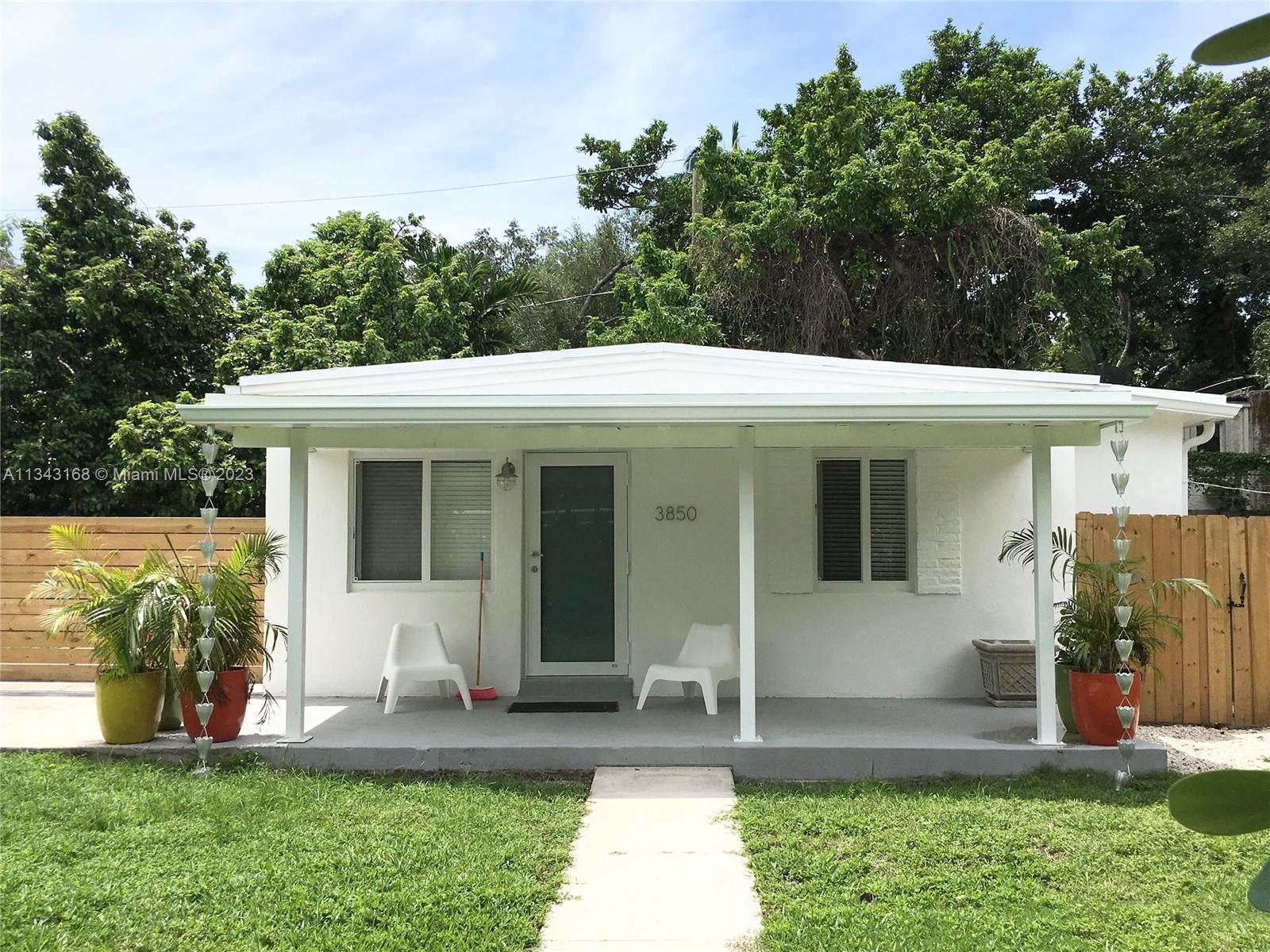 3850 Charles Terrace Coconut Grove, FL 33133 - Photo 1 of 6 a front view of a house with garden