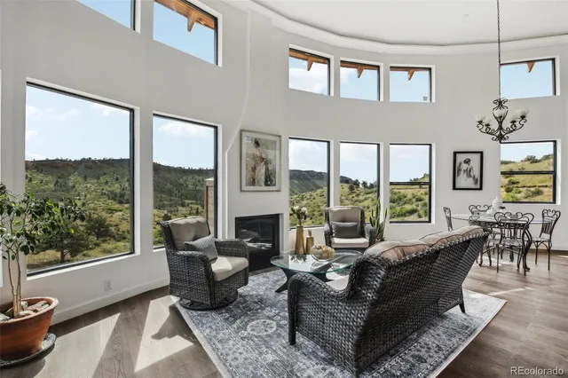 a kitchen with stainless steel appliances granite countertop a stove and a view of living room