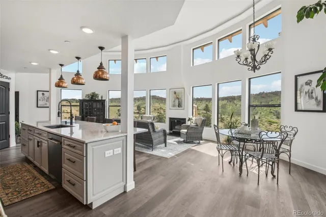 a living room with furniture and kitchen view