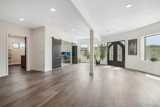 a view of a livingroom with workspace and a window