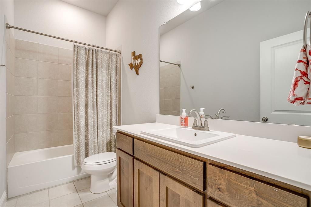 10371 Trail Ridge Drive Fort Worth, TX 76126 - Photo 23 of 35 a bathroom with a sink a toilet and shower
