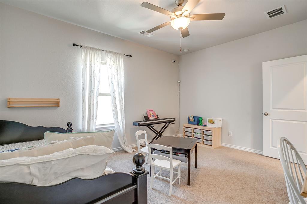 10371 Trail Ridge Drive Fort Worth, TX 76126 - Photo 28 of 35 a bedroom with a bed and a chandelier