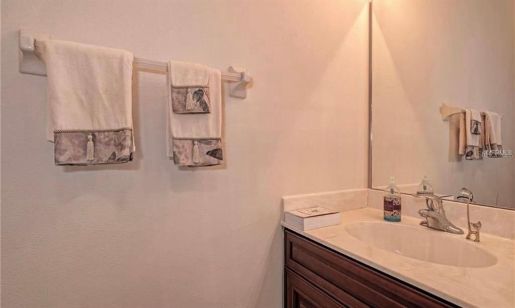 15108 Skip Jack Loop Lakewood Ranch, FL 34202 - Photo 12 of 23 a bathroom with a sink and a mirror
