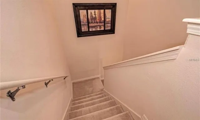 a view of staircase with white walls